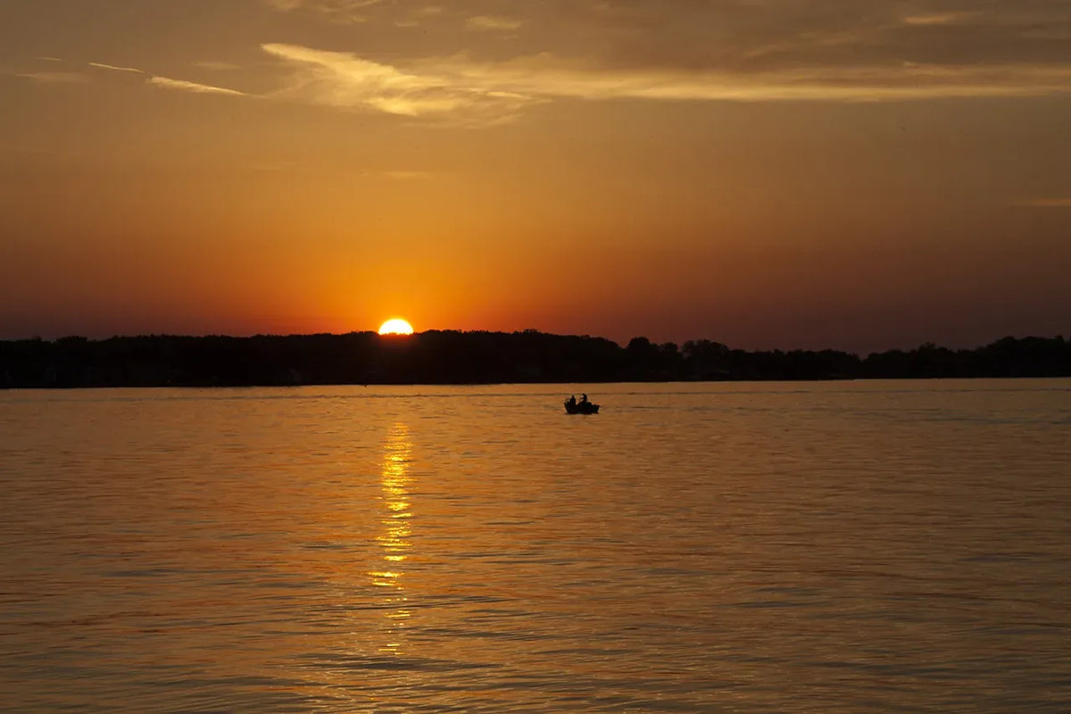 A warm sunset over a calm body of water.