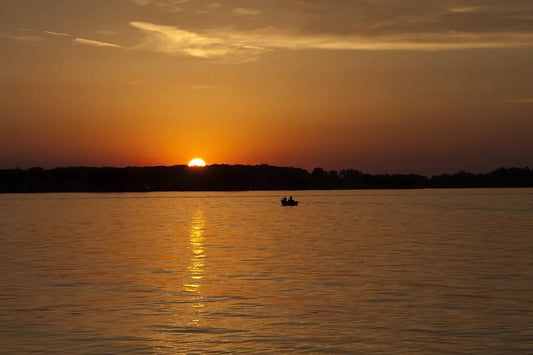 A warm sunset over a calm body of water.